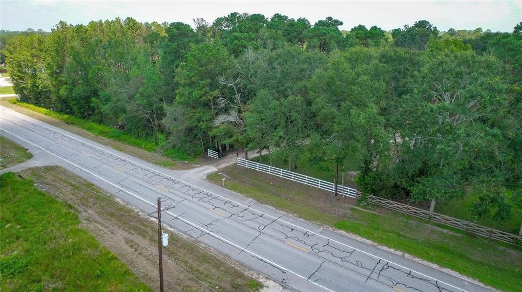 This aerial photo showcases a two-lane road and is conveniently located with direct road access to FM 1485