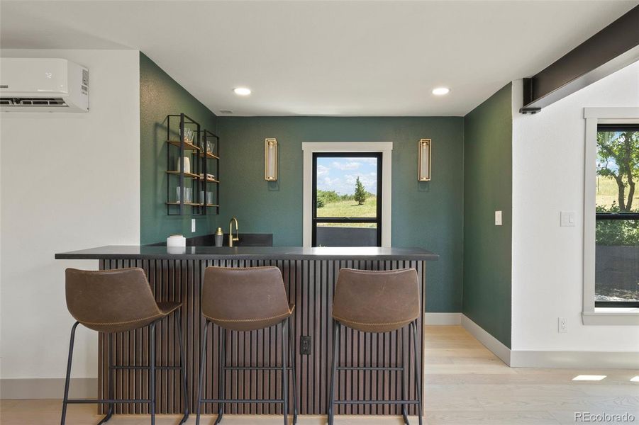 Centrally located wet bar with ice maker and beverage cooler