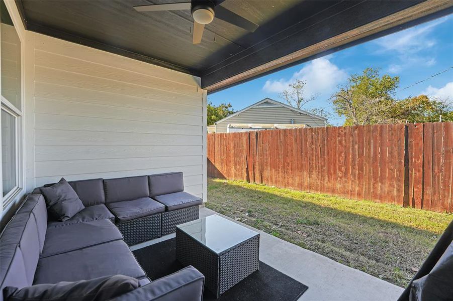 View of patio with ceiling fan and an outdoor living space