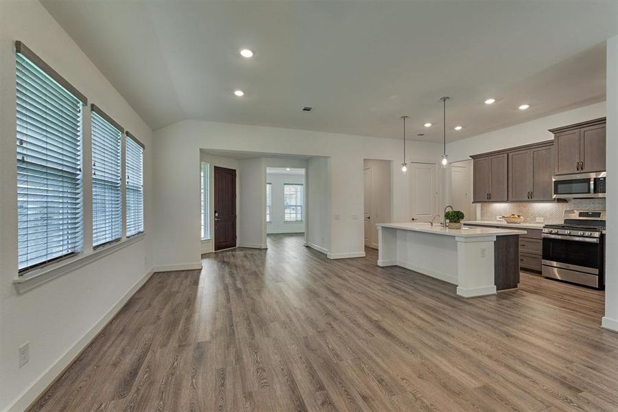 Ample space for family room and breakfast/dining room area opposite the breakfast bar/island.