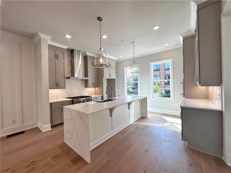 Beautiful quartz countertops on this waterfall island