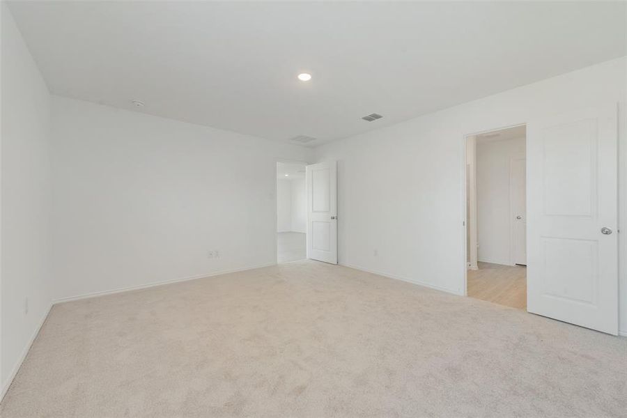 Empty room with light colored carpet