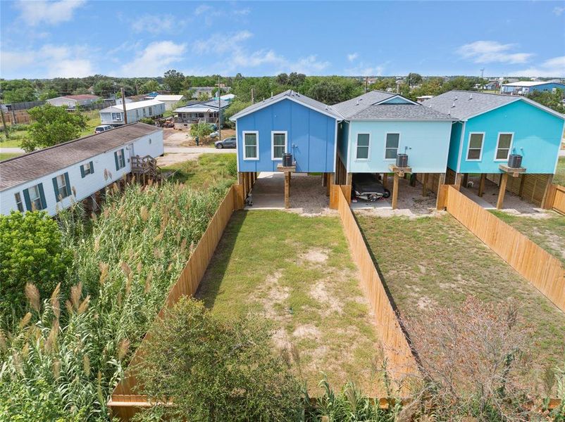 This aerial image shows the fenced back yard.