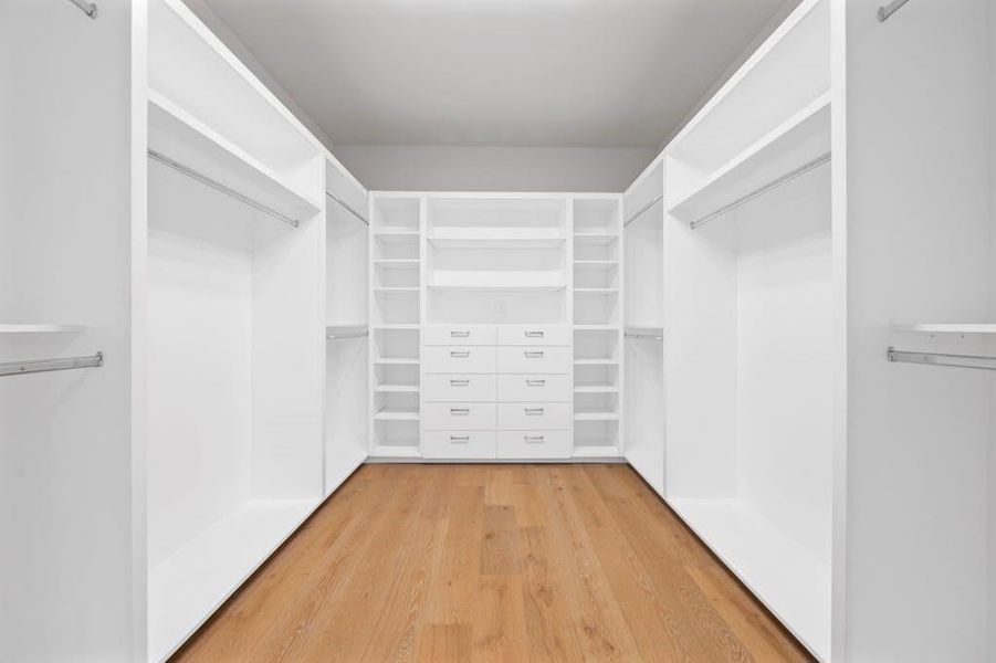 The spacious walk-in closet is a dream come true for organization enthusiasts. Featuring custom shelving, ample hanging space, and elegant built-in drawers, it provides a luxurious and efficient storage solution. The well-lit interior and thoughtful design make it easy to keep everything neatly arranged, ensuring a stylish and clutter-free environment.