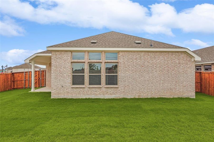 Rear view of property featuring a yard