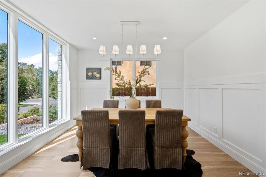 Front sitting room with floor-to-ceiling windows and wainscoting