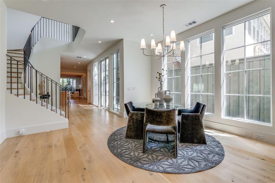 Dining space featuring a notable chandelier and light hardwood / wood-style floors