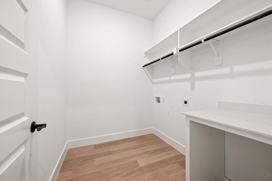 Laundry area featuring electric dryer hookup, light wood-type flooring, and hookup for a washing machine