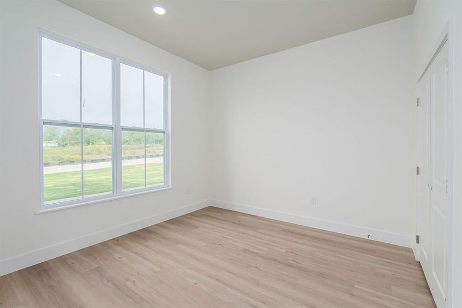 Unfurnished room with light hardwood / wood-style flooring