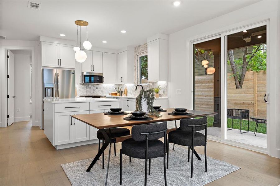 Spacious dining space looks out onto the covered patio.