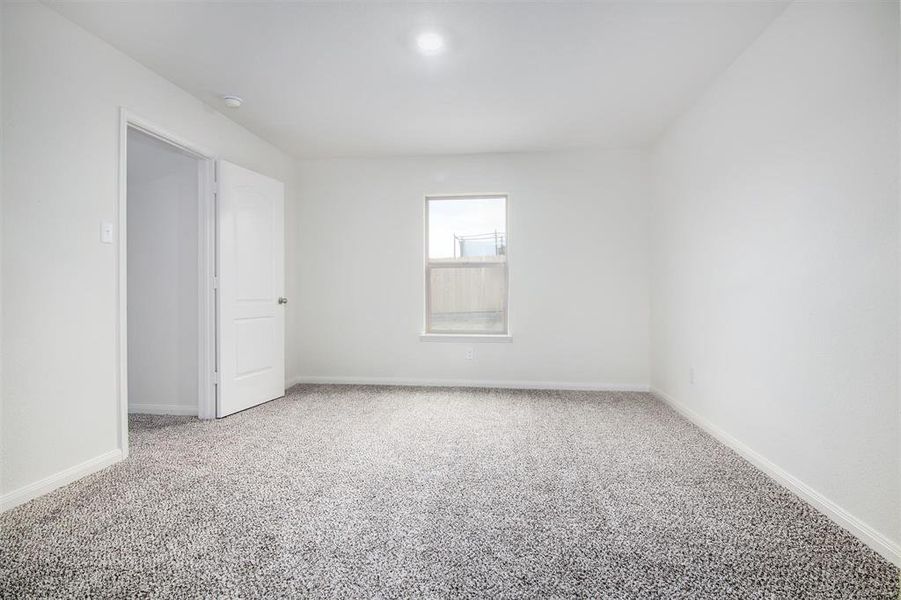 Spare room featuring carpet flooring