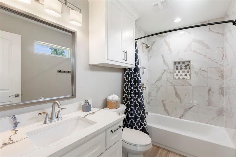 This upstairs bathroom (connected to the 4th bedroom/flex space) is gorgeous with high-end finishes and custom-built ins.