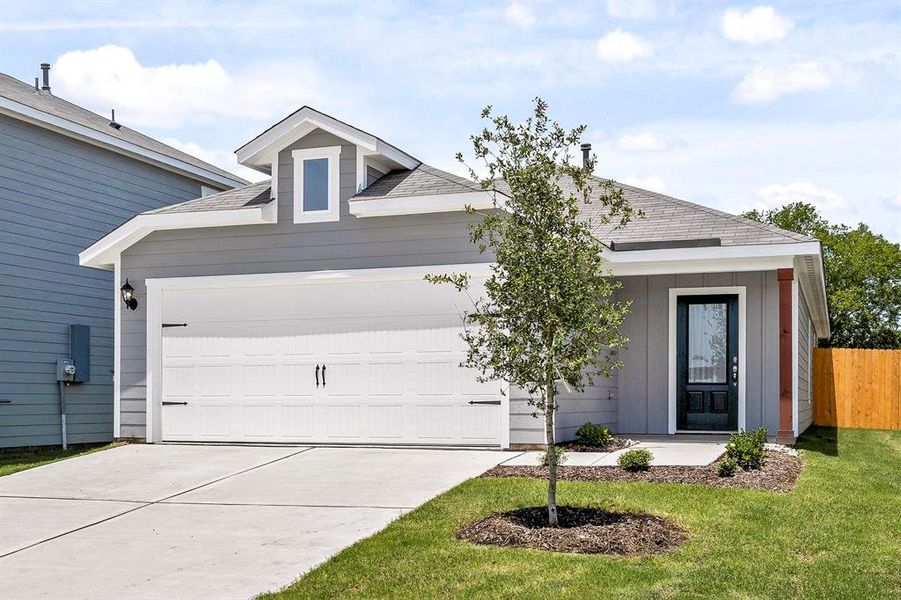 home with a garage and a front lawn