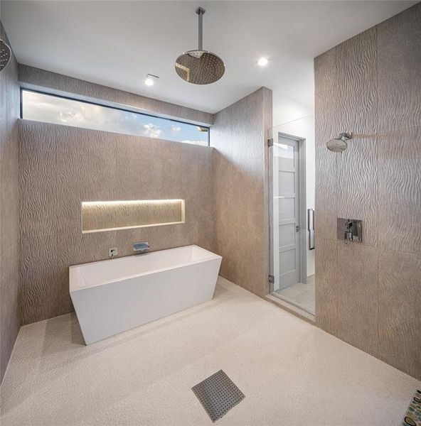 Washing area in the primary bath with porcelain soaking tub