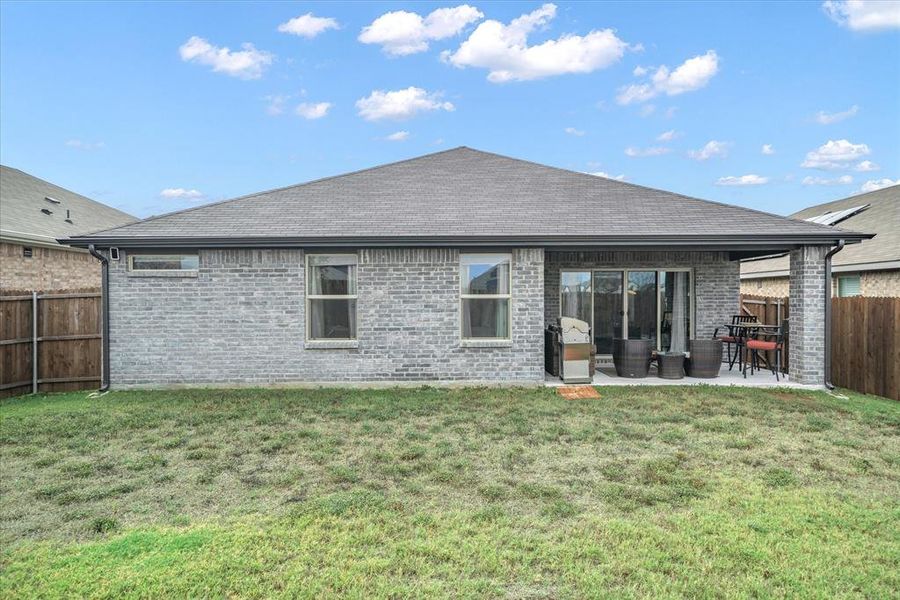 Back of house featuring covered patio area and yard.