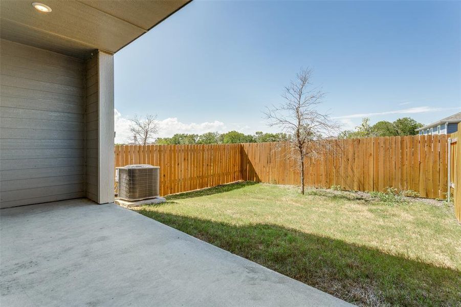 View of yard with a patio and central AC unit