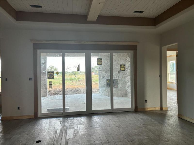 Entryway with wood ceiling, beamed ceiling, dark hardwood / wood-style floors, and a healthy amount of sunlight