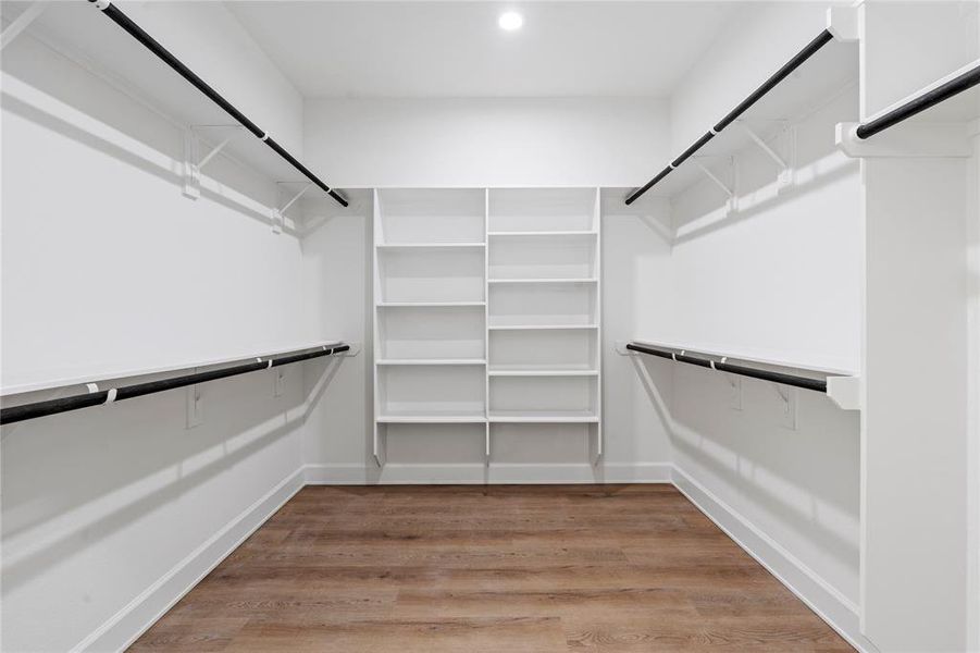 An oversized walk-in closet with shelves, offering ample storage space for your wardrobe essentials. Perfectly designed to enhance organization and convenience in your daily routine.