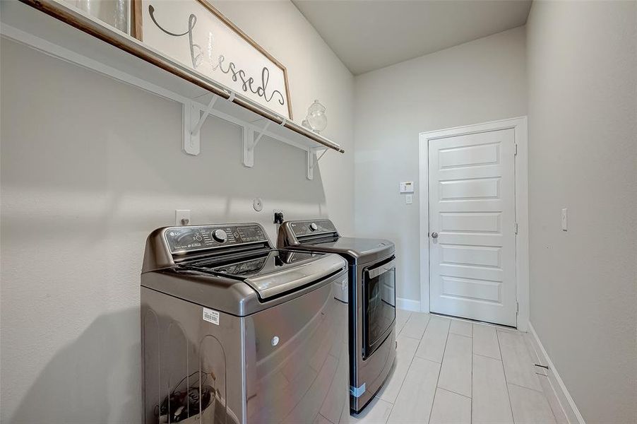 The laundry room features tile floors,washer and dryer connections, andplenty of storage space.