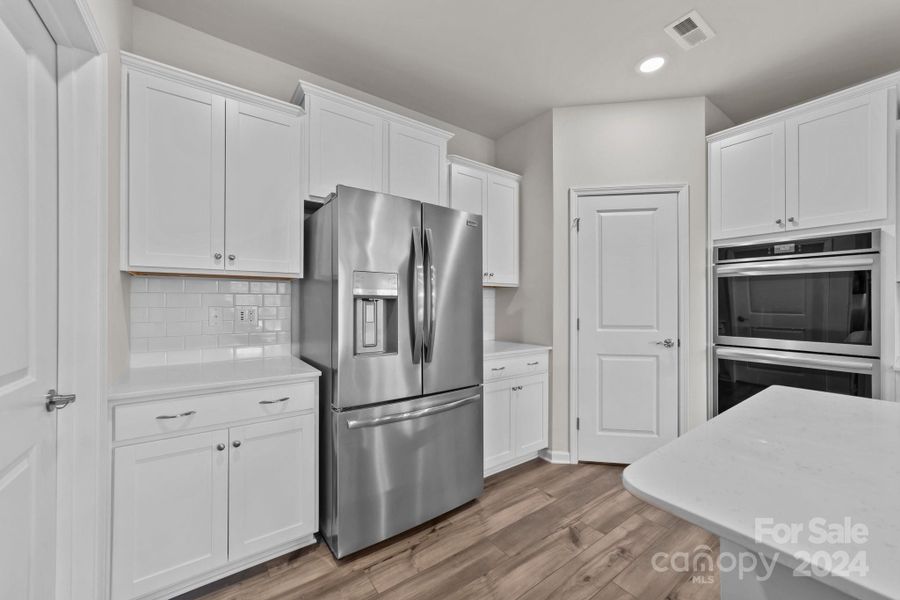 Walk in pantry, double wall ovens, and PLENTY of cabinetry! Refrigerator negotiable.