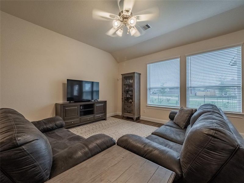 this is the family room, great view, open file floors, ceiling fan and oversized windows
