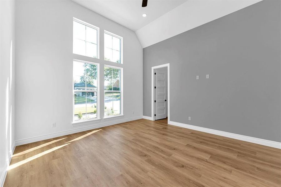 First bedroom located at the front of the house has high vaulted ceilings, 3 switch LED ceiling fan, large walk-in closet and en-suite bathroom.