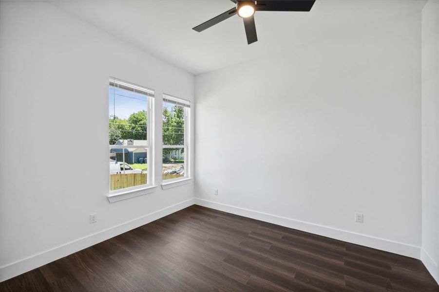 Spare room featuring dark hardwood / wood-style floors and ceiling fan