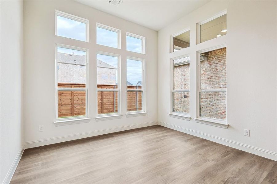 Empty room with light hardwood / wood-style floors