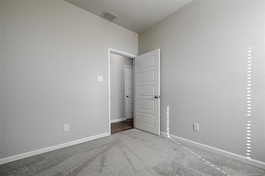 Unfurnished bedroom with carpet