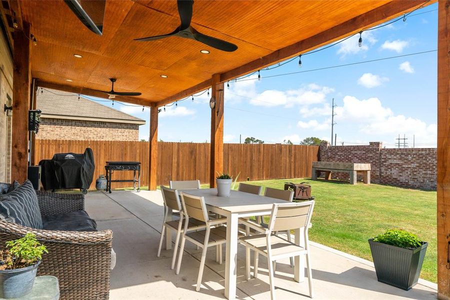 Relax on the extended covered patio with ceiling fans was just added to the home.