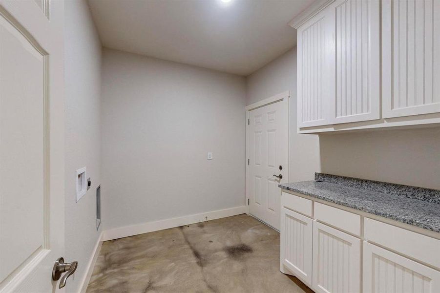 Laundry area featuring cabinets, electric dryer hookup, and washer hookup