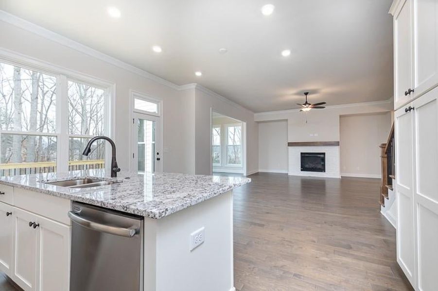 The entertainer's kitchen is a standout feature, boasting a sizable kitchen island. Photo not actual home, but previously built Mansfield plan.