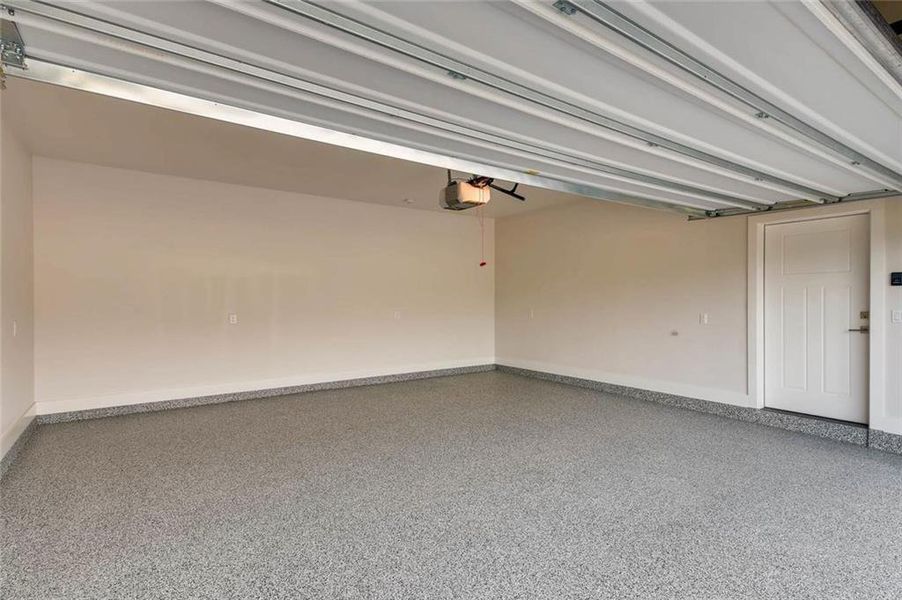 Enormous garage with garage door opener and electric car plug option. Epoxy is an upgrade.