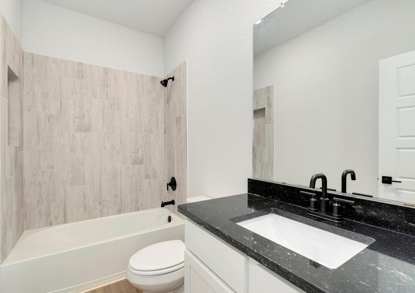 Secondary bathroom with a single sink and dual shower and bath tub.