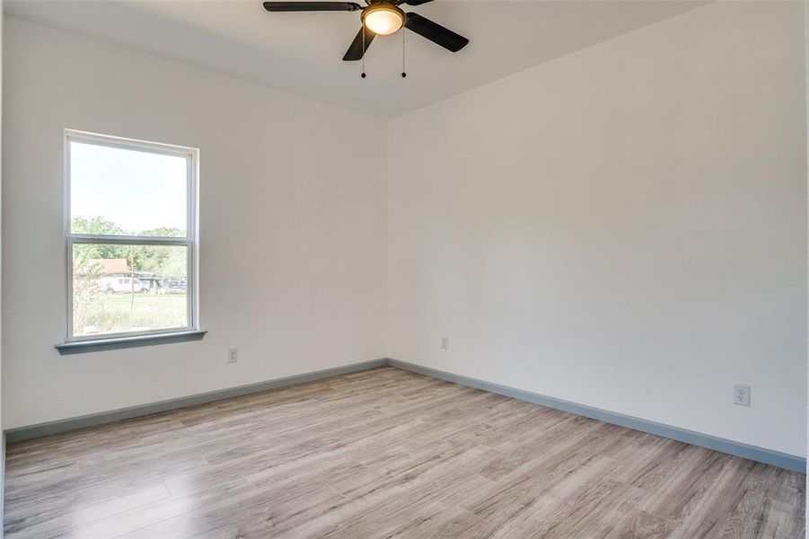 Spare room featuring light wood-type flooring and ceiling fan