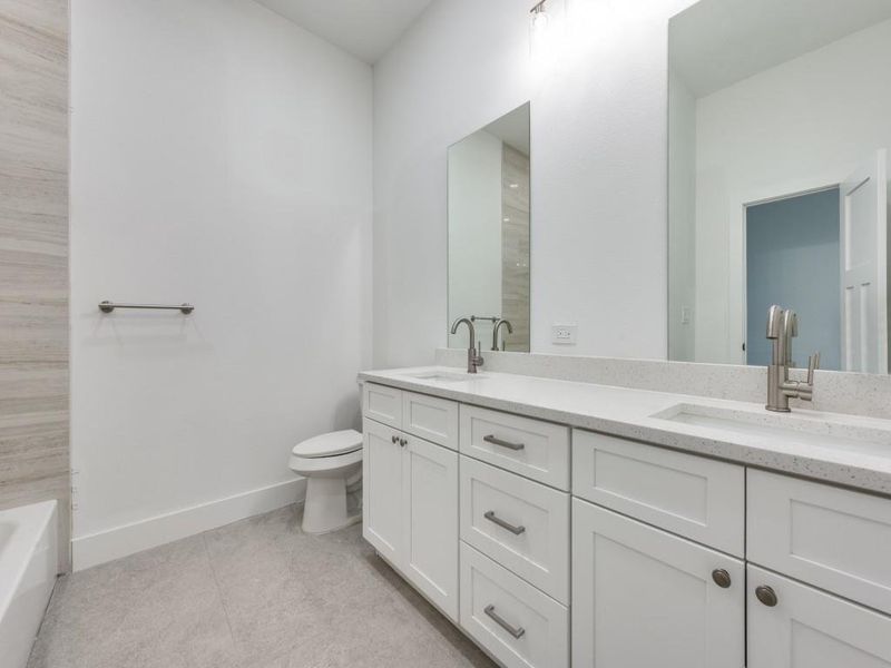 Full bathroom with vanity, tile patterned flooring, toilet, and plus walk in shower