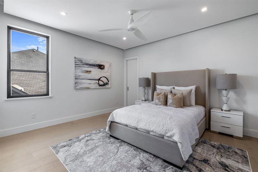 Bedroom with ceiling fan and hardwood / wood-style flooring