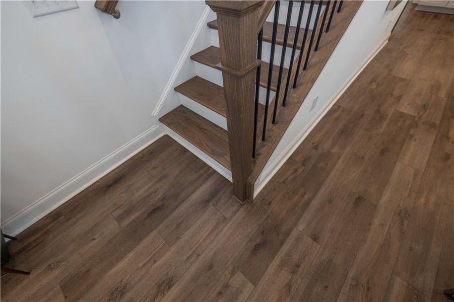 Staircase with dark wood-type flooring going upstairs in the Open Concept Kitchen and Living Room , not the actual unit