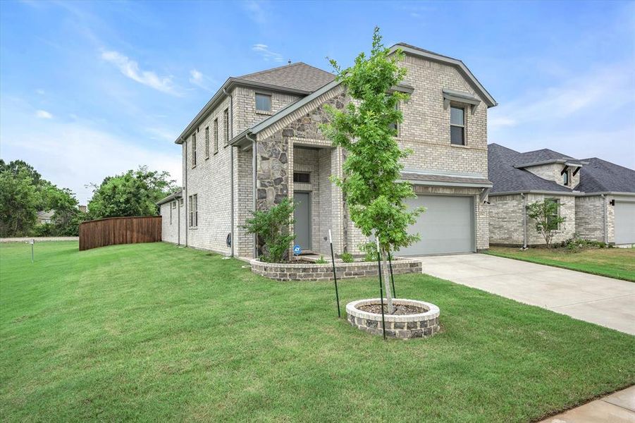 View of front of property with a front lawn and a garage