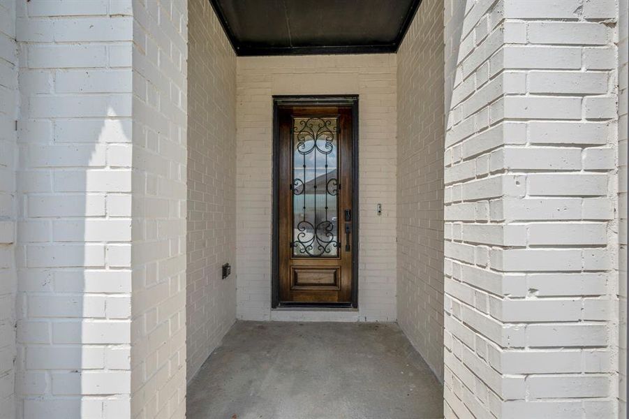 Approaching the front door you find a spacious front porch to welcome guests! It's finished with a 8ft Mahogany front door, smart door bell, and keyless entry.