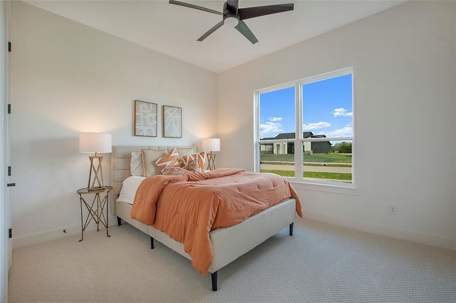 Carpeted bedroom with ceiling fan