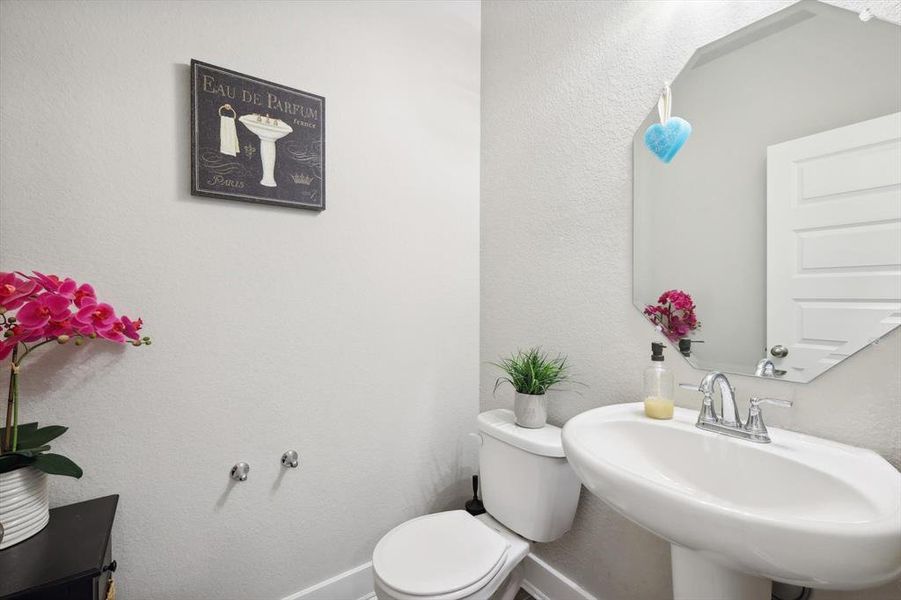 Bathroom featuring sink and toilet