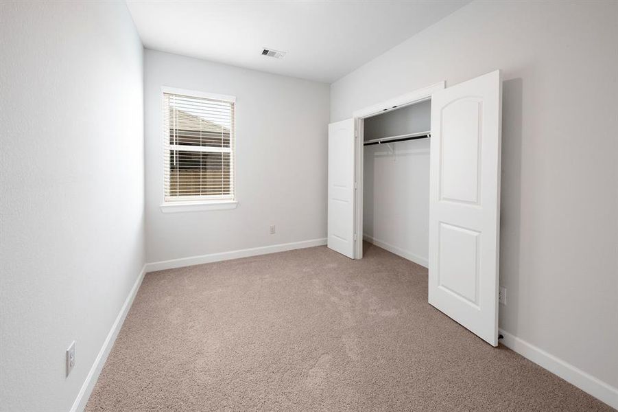 The secondary bedrooms are spacious and offer plenty of closet space.