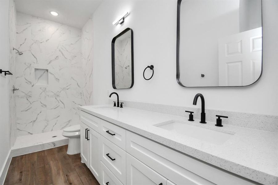 Primary bathroom with dual sinks and a spacious walk in shower