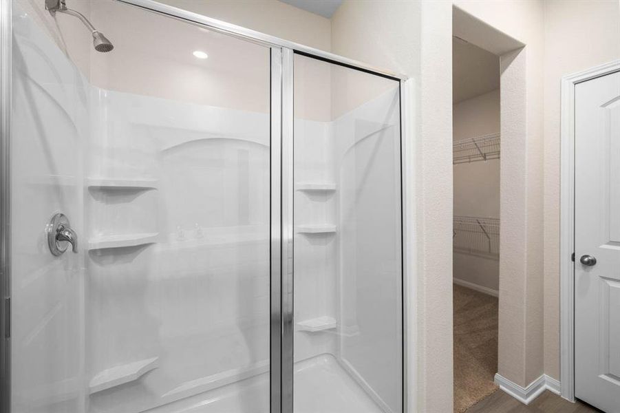 Primary Bathroom includes a walk in shower.