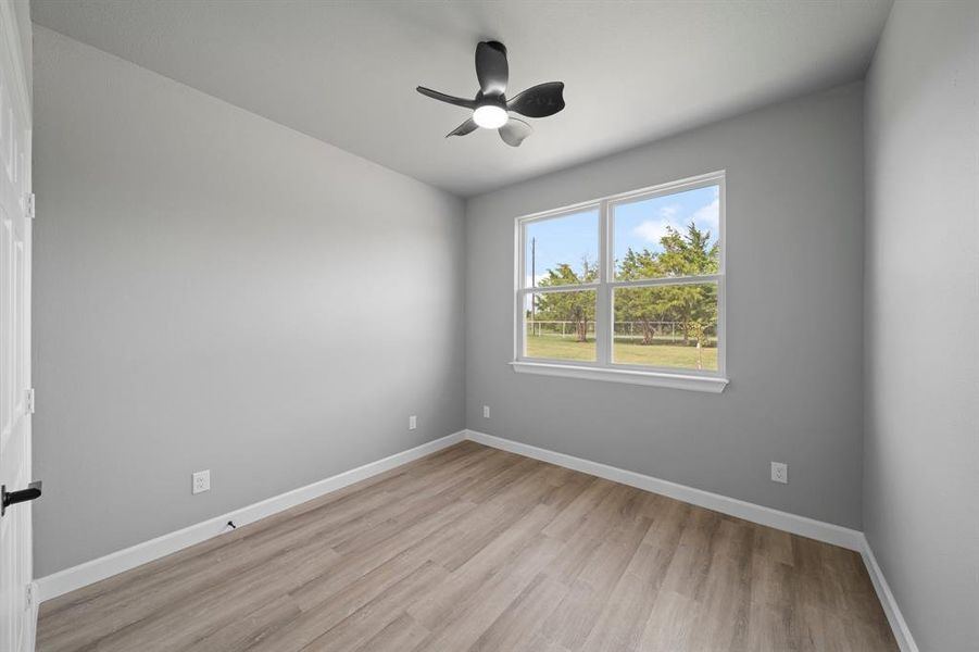 Spare room with light hardwood / wood-style floors and ceiling fan