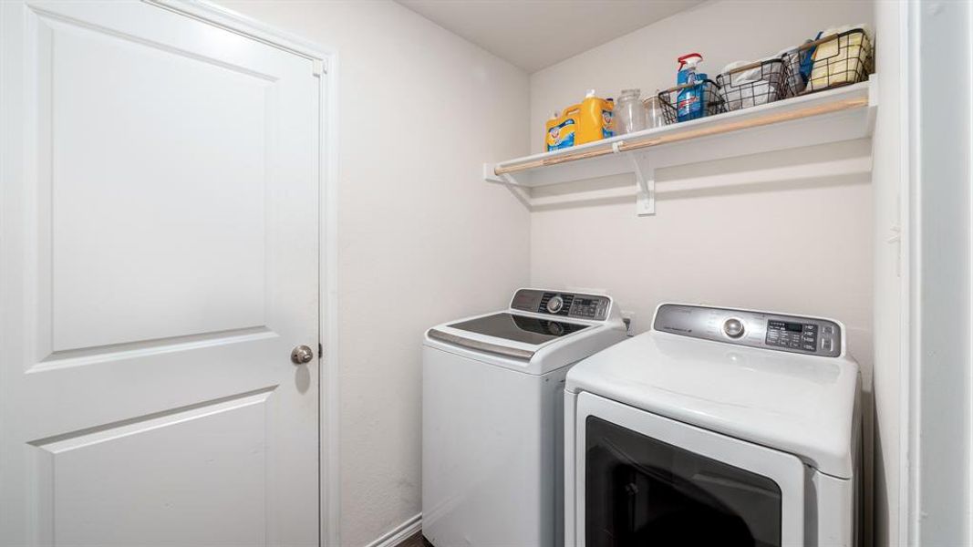 Washroom featuring washing machine and dryer