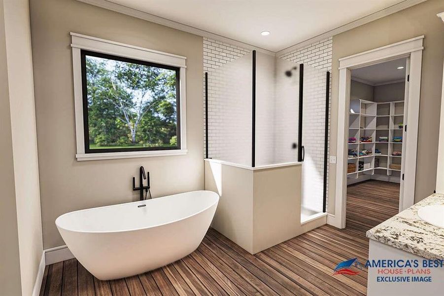 Bathroom featuring vanity, crown molding, hardwood / wood-style flooring, and a tub to relax in