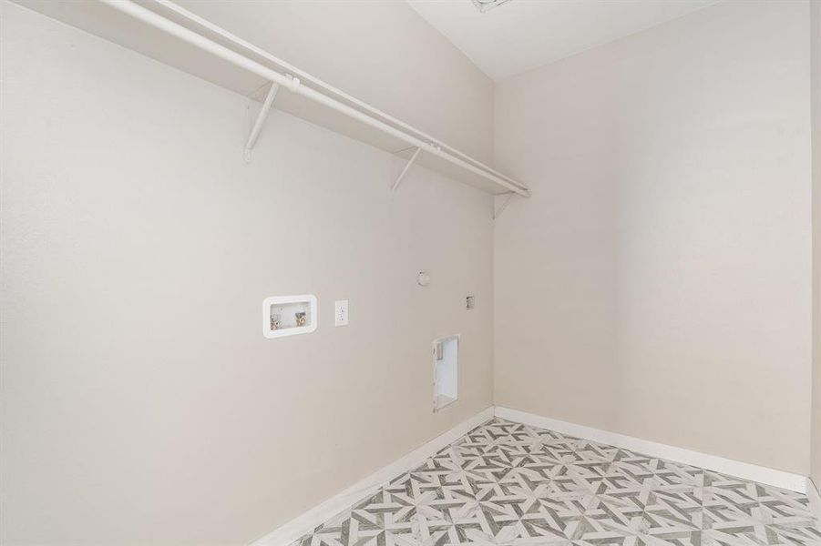 Clothes washing area with hookup for a gas dryer, hookup for an electric dryer, and washer hookup