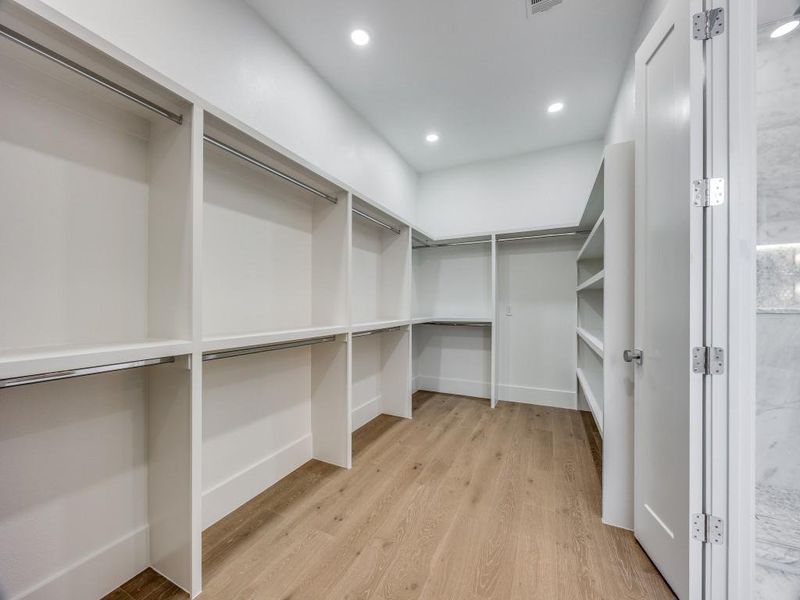 Spacious closet with light hardwood / wood-style floors